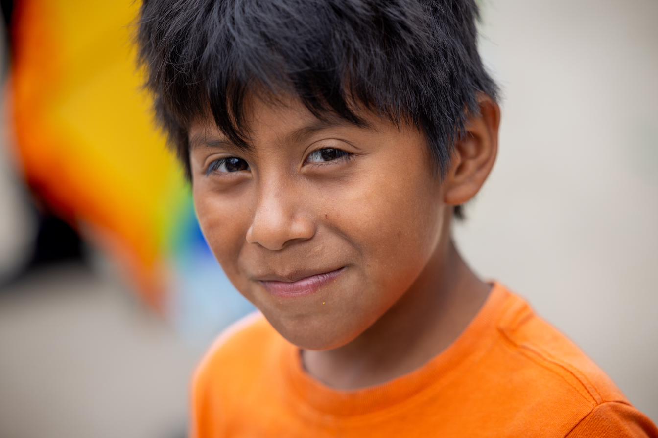 A thoughtful young boy in a navy sweater