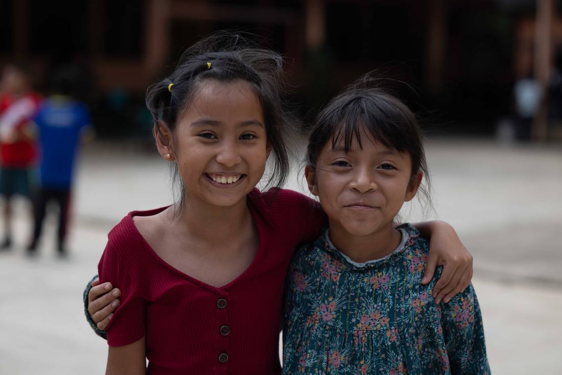 Two students smiling together at school