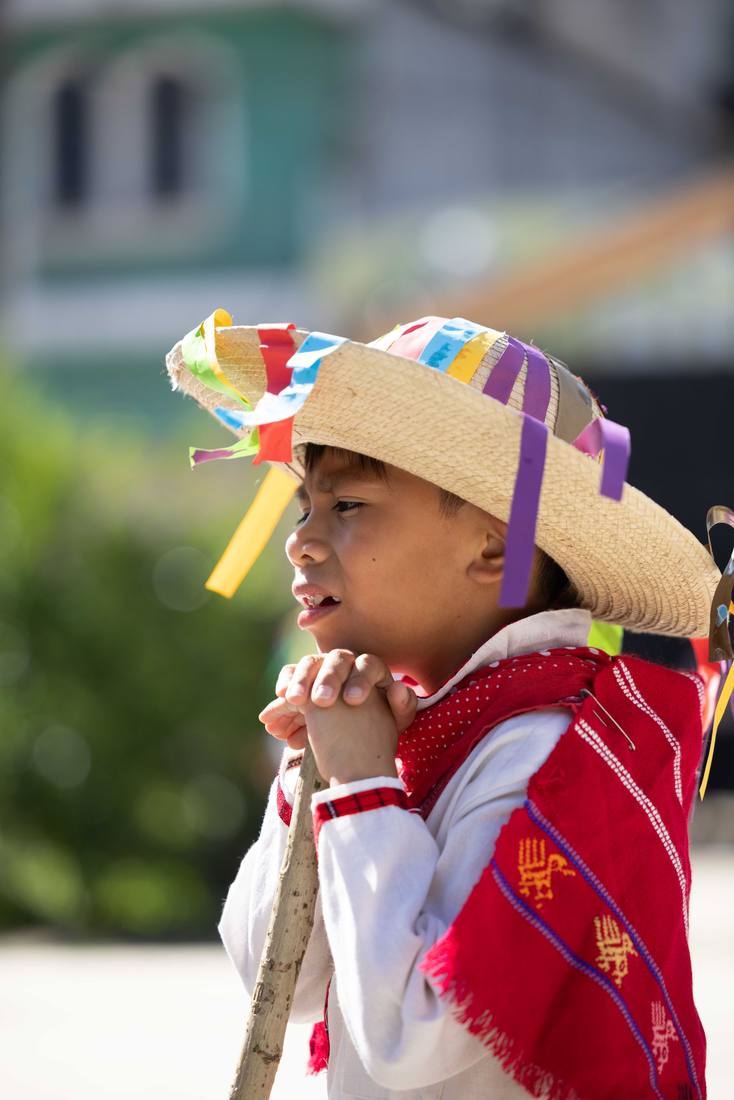 A student in traditional Guatemalan dress at a school celebration