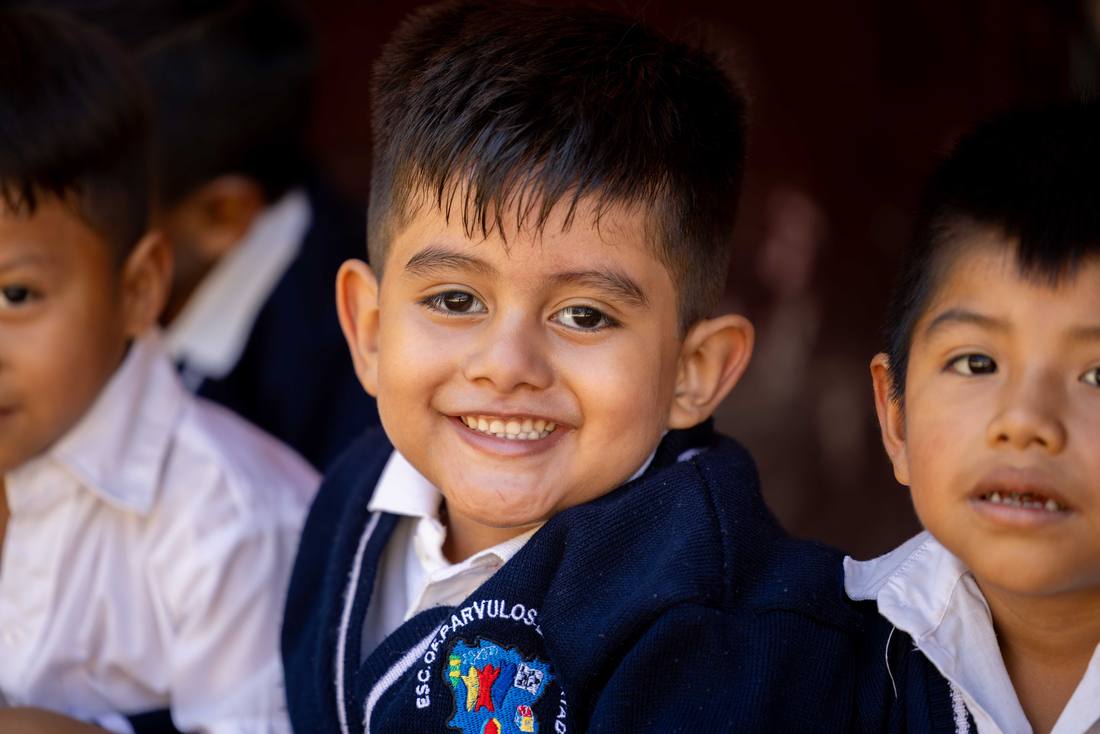A student smiling in his school uniform